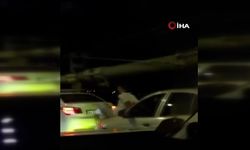 Aracın kaputuna oturdu, önündeki arabayı ayağıyla itti